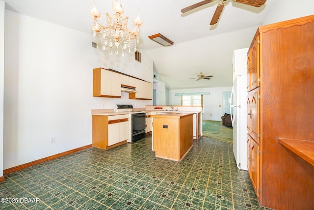 355 Palm Cir, Flagler Beach, FL 32136 - kitchen featuring electric range oven, a ceiling fan, a sink, vaulted ceiling, and light countertops