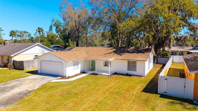 single story home featuring a front lawn, an attached garage, and fence