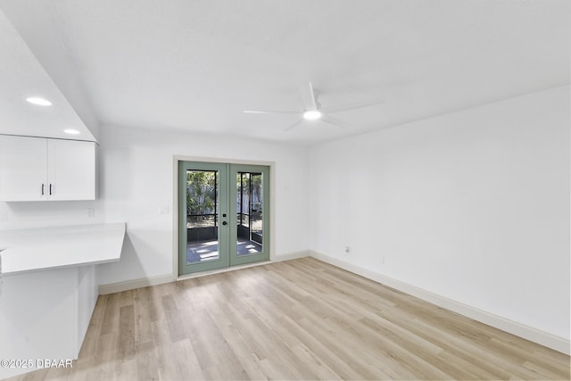 interior space featuring a ceiling fan, french doors, light wood-type flooring, and baseboards