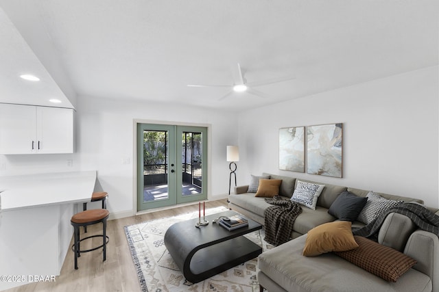 living area featuring baseboards, recessed lighting, light wood-style flooring, french doors, and a ceiling fan