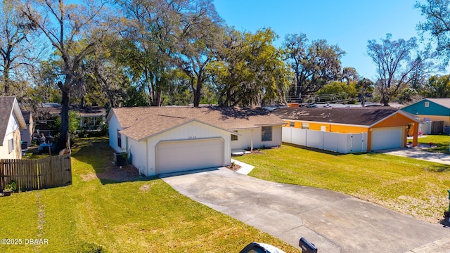 single story home with a front yard, cooling unit, fence, driveway, and a garage