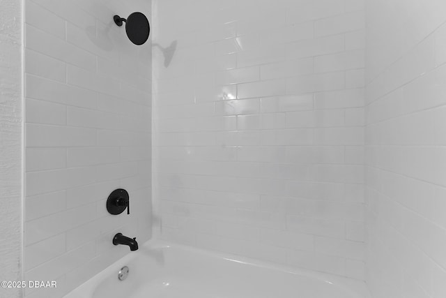 interior details with shower / washtub combination