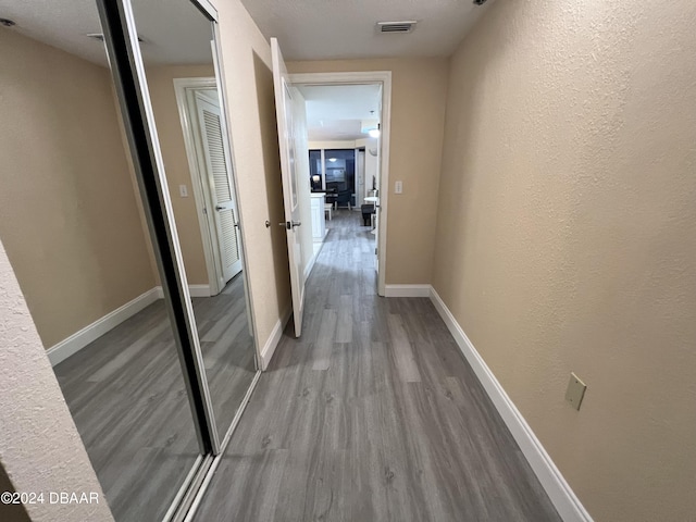 corridor with light wood-type flooring