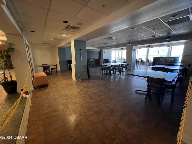 dining area with a paneled ceiling