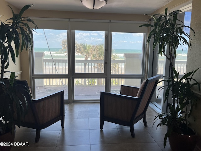 sitting room with a water view and a beach view