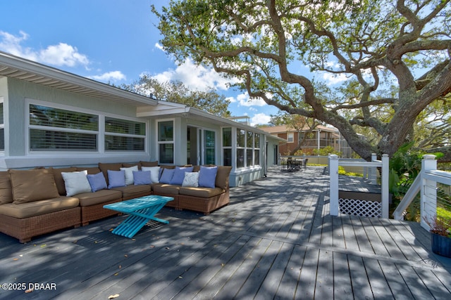 wooden terrace with an outdoor living space