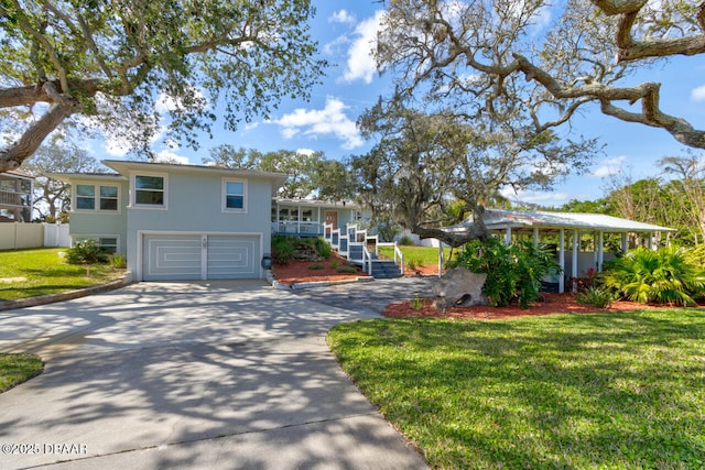 view of front of property with a garage, covered porch, and a front lawn