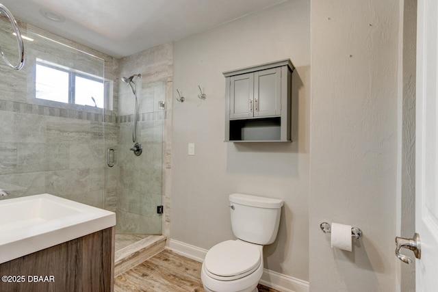 bathroom with vanity, hardwood / wood-style flooring, toilet, and walk in shower