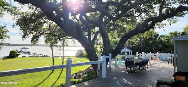 wooden terrace with a gazebo, a lawn, and a water view