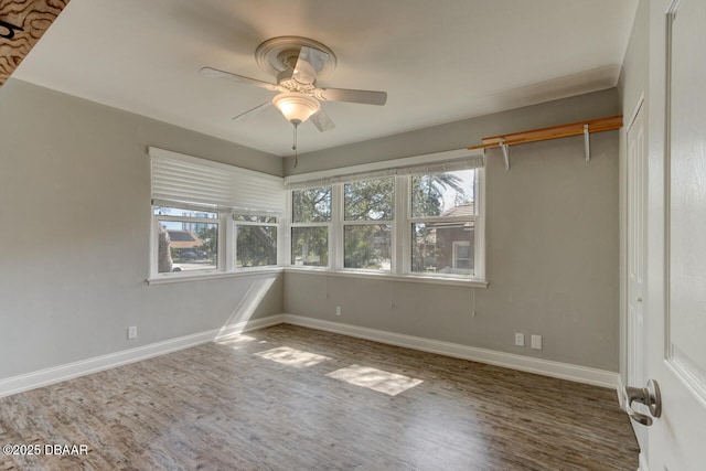 interior space featuring dark wood-type flooring and ceiling fan