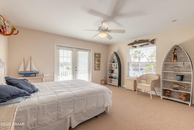 bedroom with access to outside, light colored carpet, and ceiling fan