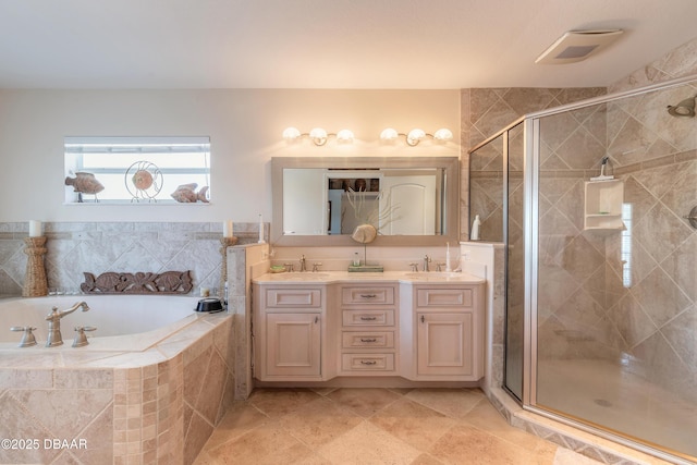 bathroom featuring vanity and independent shower and bath