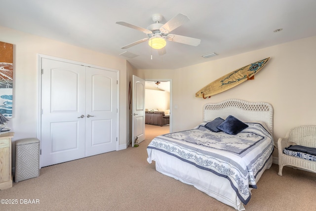 bedroom featuring ceiling fan, a closet, and carpet