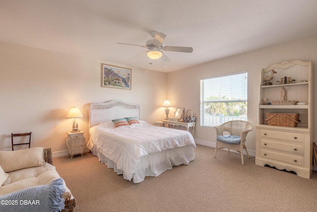 bedroom with ceiling fan and light carpet