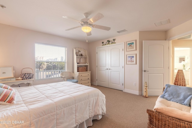 carpeted bedroom with ceiling fan and a closet