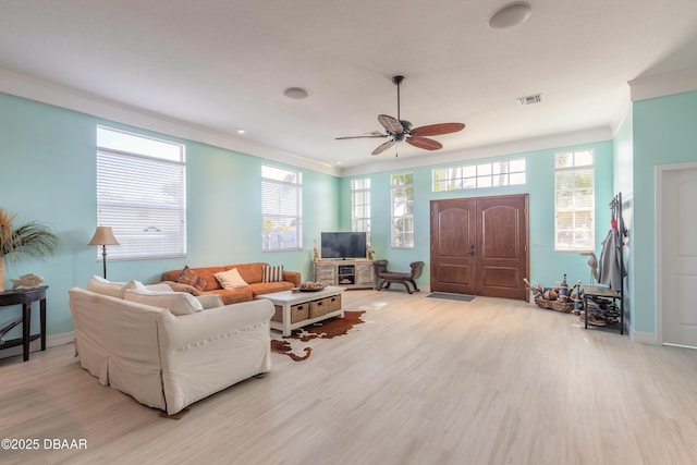 living room with ceiling fan, crown molding, and light hardwood / wood-style flooring