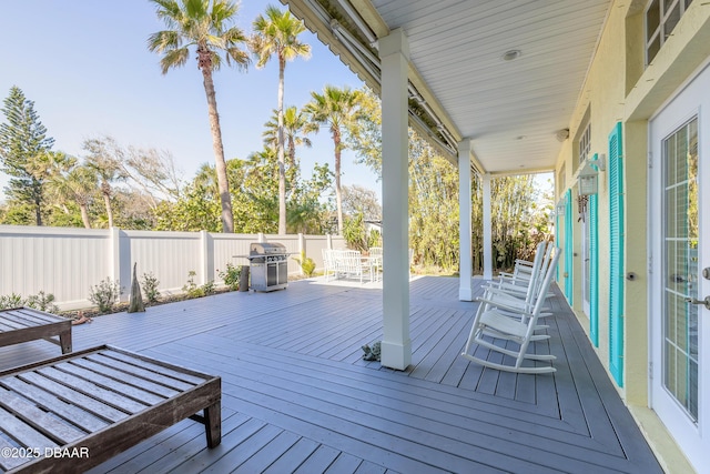 wooden terrace featuring covered porch and grilling area