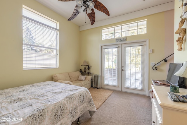 bedroom featuring light carpet, radiator, access to outside, french doors, and ceiling fan