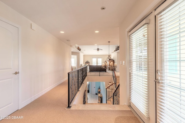 corridor featuring carpet and a chandelier