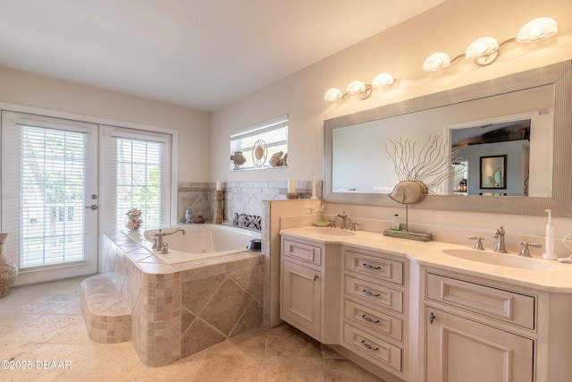 bathroom with tiled tub and vanity