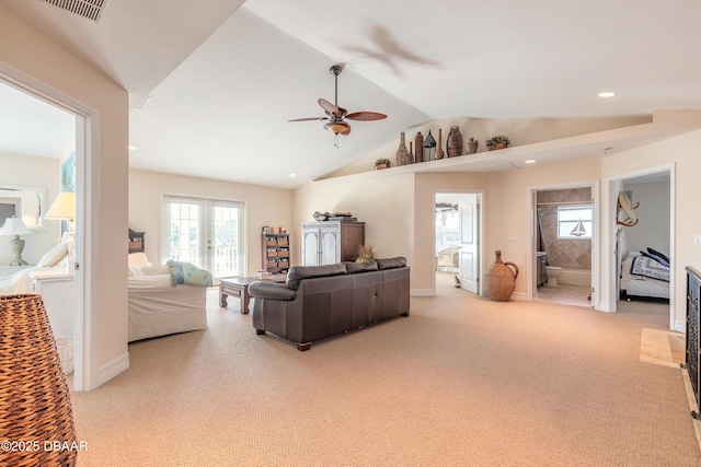 living room featuring ceiling fan, light colored carpet, and vaulted ceiling