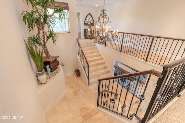 staircase with an inviting chandelier