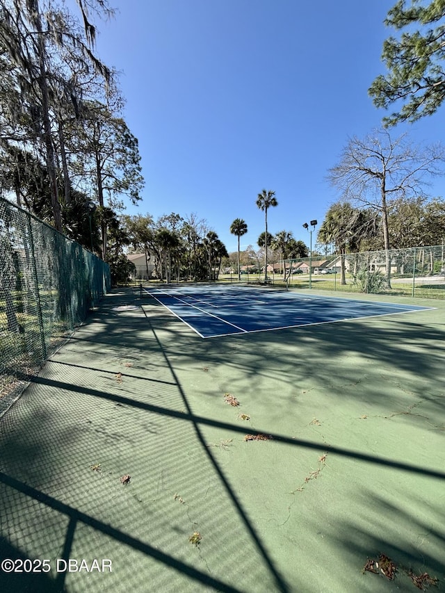 view of tennis court with fence