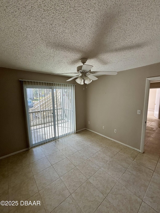 spare room with a ceiling fan, a textured ceiling, baseboards, and light tile patterned floors