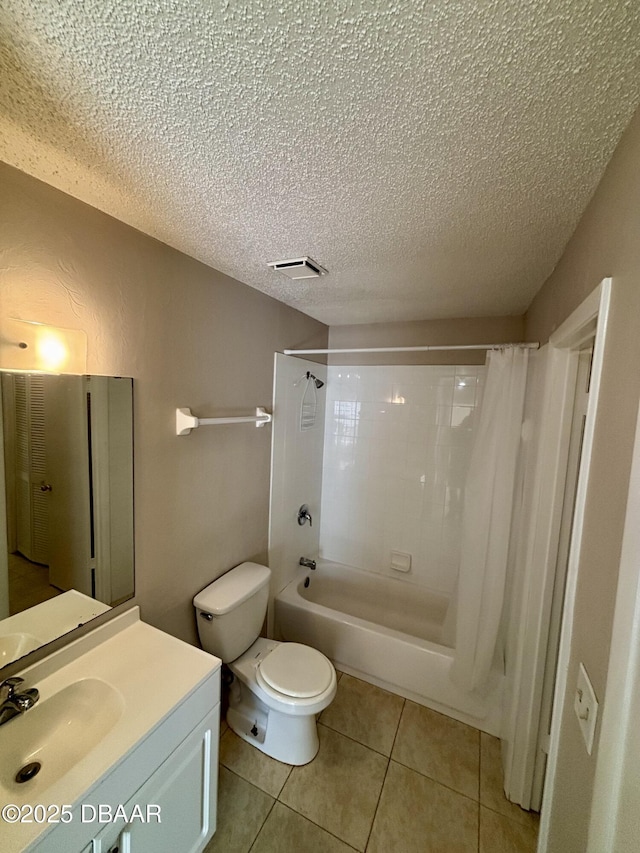 bathroom featuring a textured ceiling, toilet, vanity, tile patterned floors, and shower / bath combination with curtain