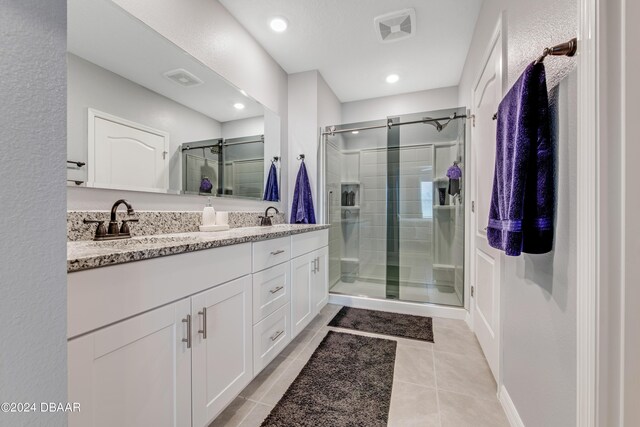 1362 Cork Dr, Ormond Beach, FL 32174 - full bathroom featuring a shower stall, double vanity, tile patterned floors, and recessed lighting