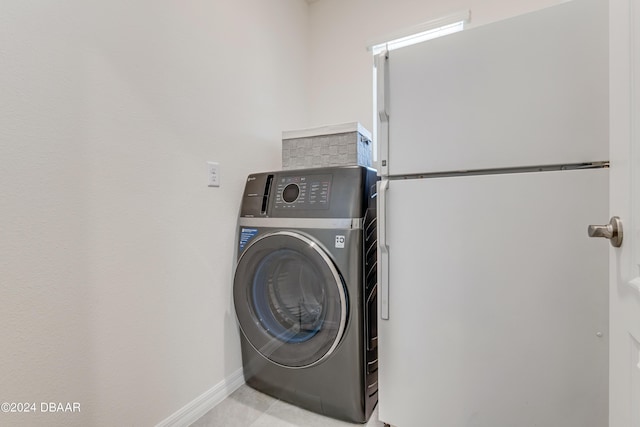 1362 Cork Dr, Ormond Beach, FL 32174 - laundry area with washer / clothes dryer and baseboards