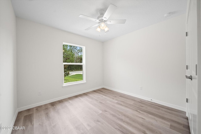 spare room with ceiling fan, a textured ceiling, and light hardwood / wood-style floors