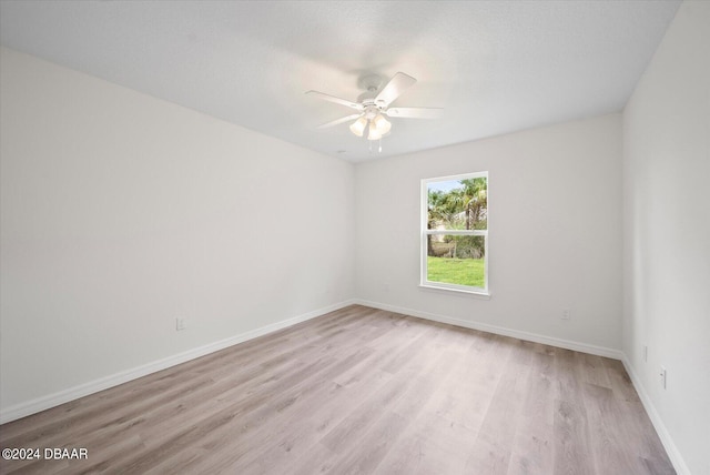 spare room featuring ceiling fan and light wood-type flooring