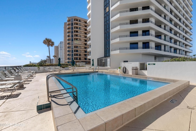 community pool with a patio area