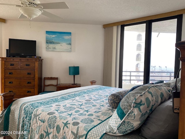 bedroom featuring ceiling fan and a textured ceiling