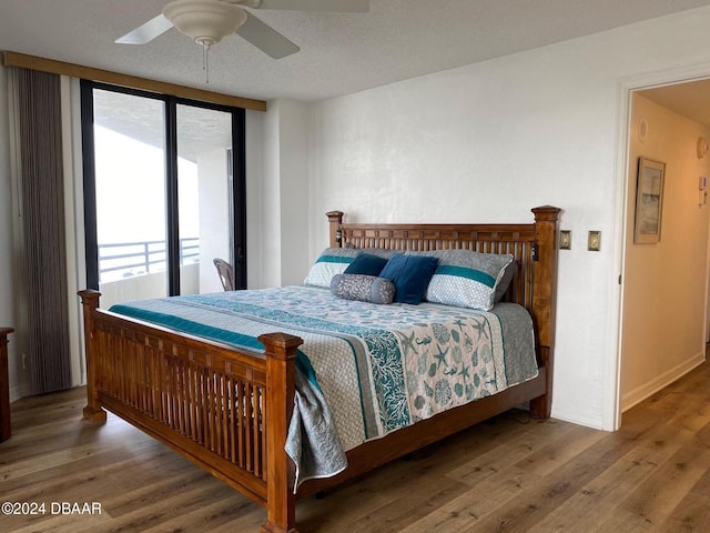 bedroom featuring baseboards, a ceiling fan, and wood finished floors