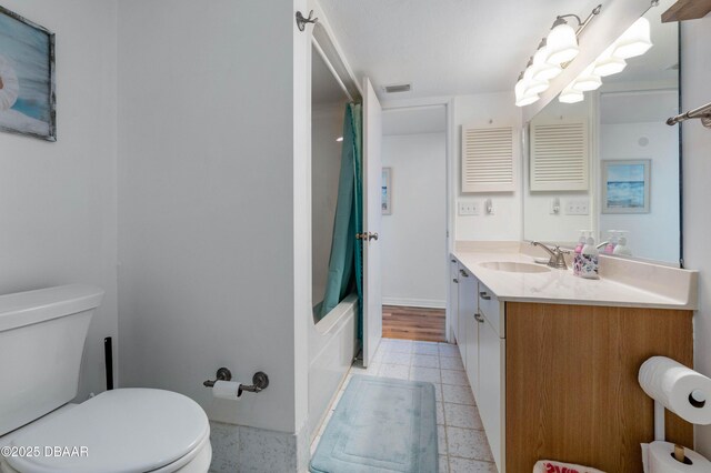 bathroom featuring tile patterned flooring, vanity, and toilet