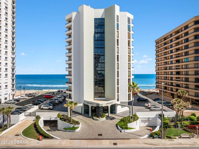 view of property featuring a water view and a view of the beach