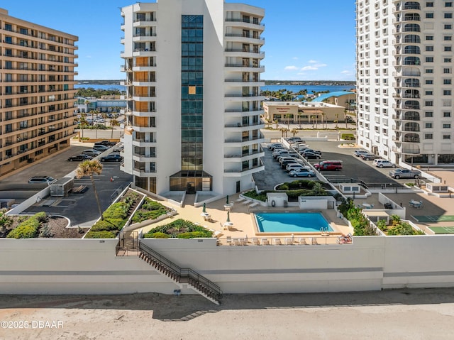 view of building exterior with a view of city and a water view