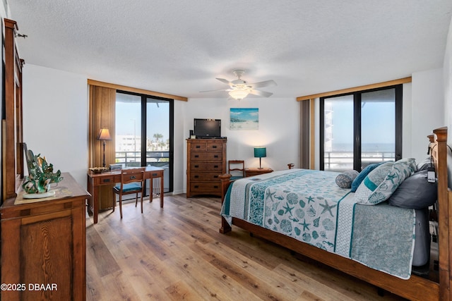 bedroom with a textured ceiling and wood finished floors