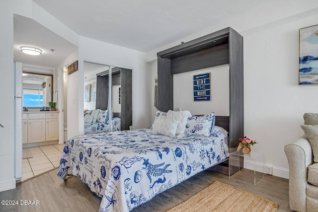 bedroom with wood-type flooring and a closet