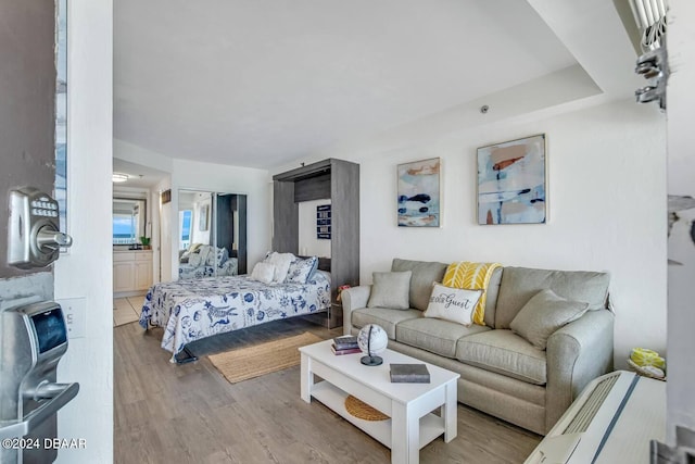 bedroom with light hardwood / wood-style flooring and ensuite bath