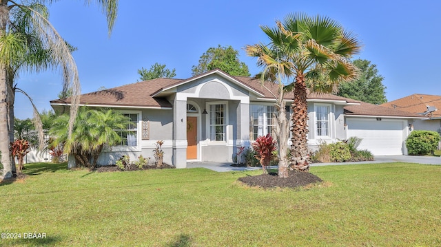 view of front facade featuring stucco siding, a garage, concrete driveway, and a front lawn