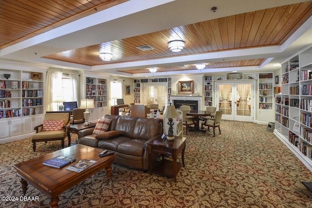 living room featuring carpet, french doors, a raised ceiling, and wooden ceiling