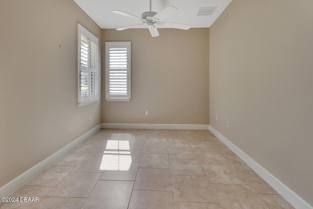 unfurnished room featuring light tile patterned floors and ceiling fan