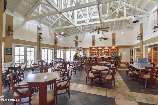 dining space with beam ceiling and high vaulted ceiling