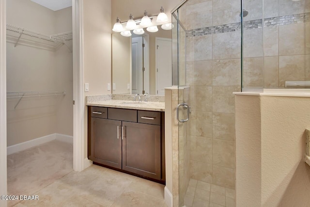 bathroom featuring tile patterned floors, vanity, and walk in shower