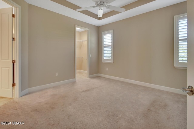 spare room featuring light carpet and ceiling fan