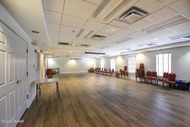 workout room featuring hardwood / wood-style floors and a paneled ceiling