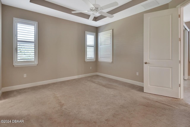 empty room featuring light carpet and ceiling fan